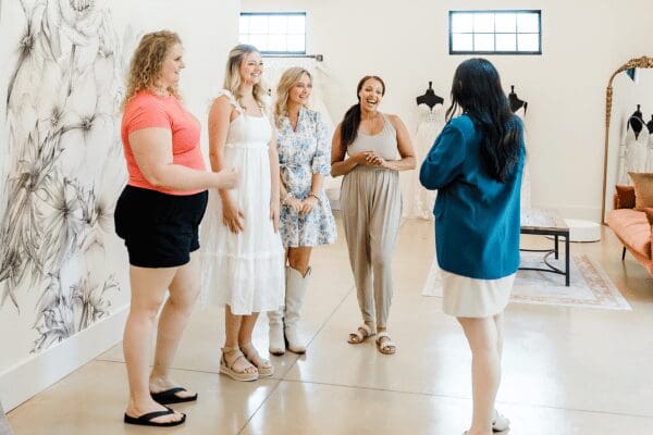 A bride and her bridal party listening to the bridal stylist