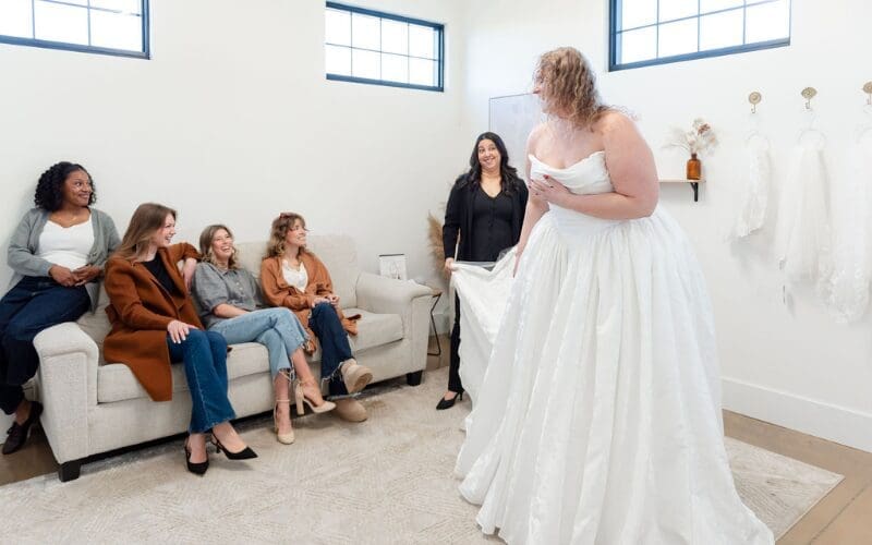 Bride showing her wedding dress to friends during a bridal appointment