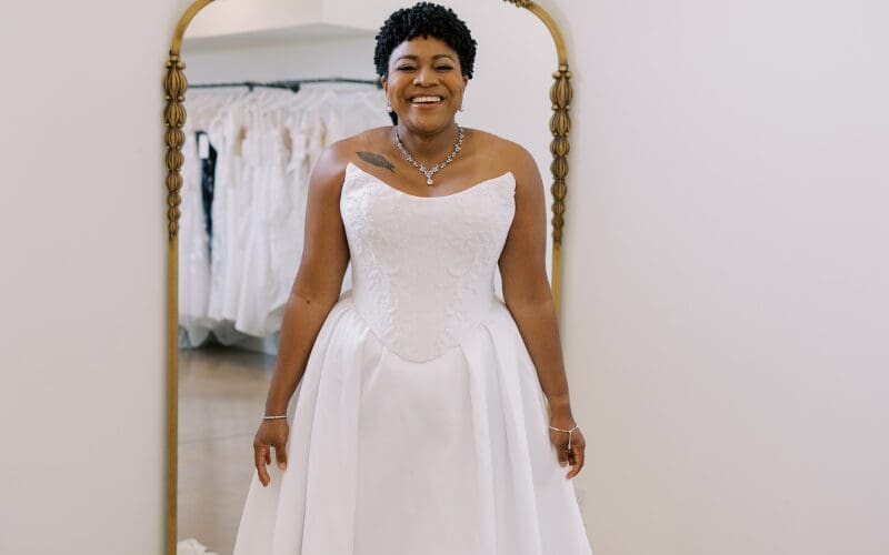 Bride wearing an off-the-shoulder lace wedding dress with long sleeves