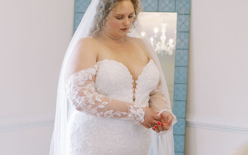 Bride wearing a lace wedding gown and veil during her bridal appointment