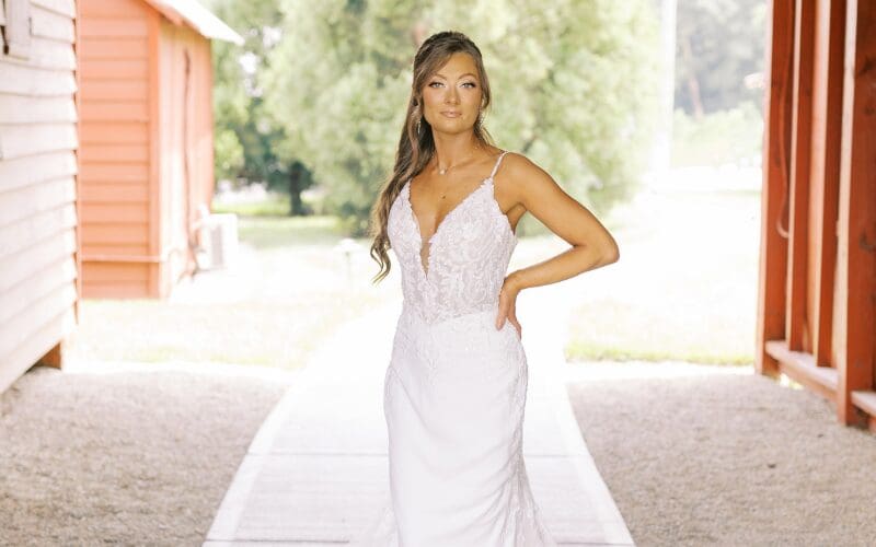 Bride wearing a fitted lace wedding dress with a plunging neckline
